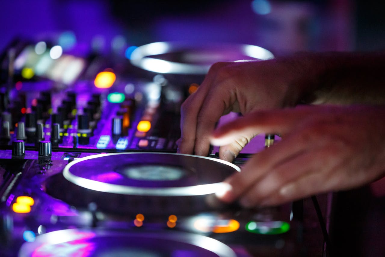 DJ mixing music at a lively nightclub in Bucharest with vibrant lights.